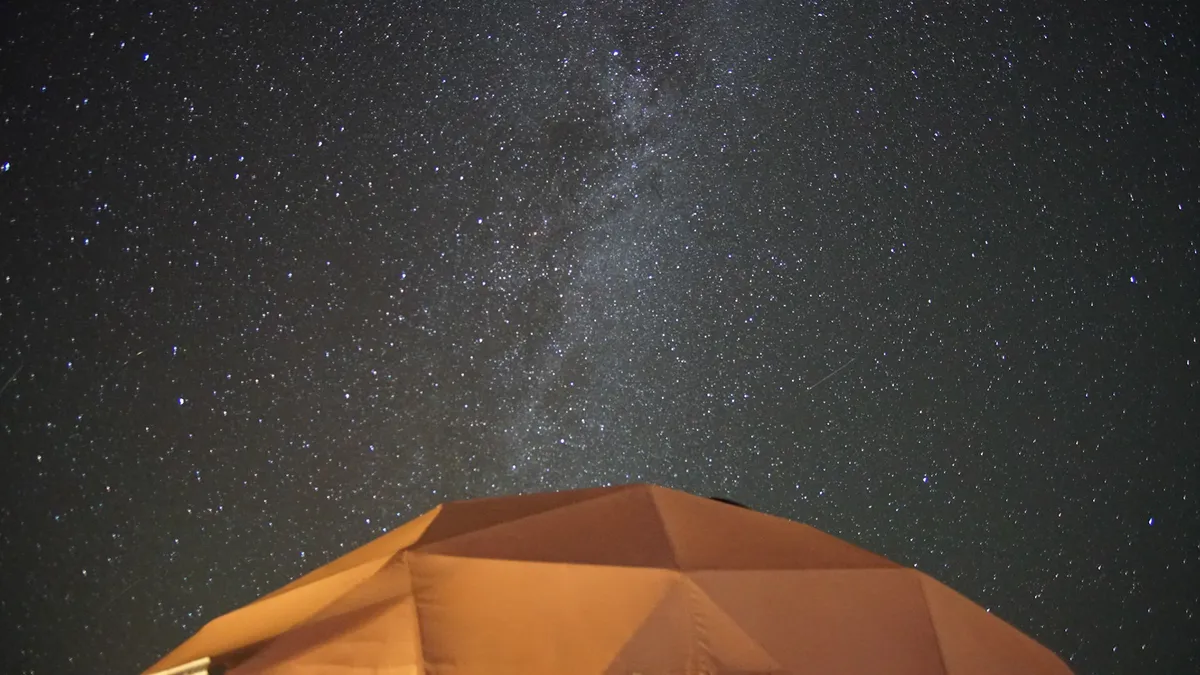 Stars and the Milky Way above the roof of a resort dome